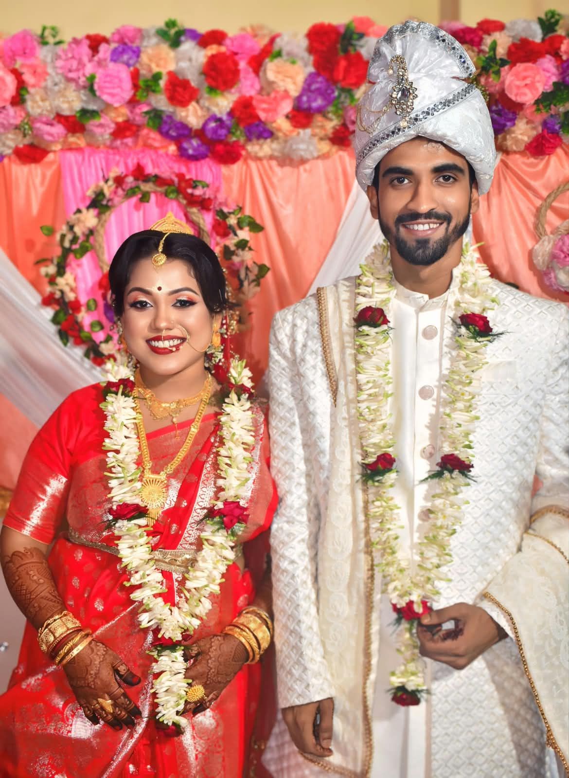 Tabassum and Sakil on their wedding day, wearing flower garlands